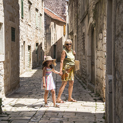 Grandma and granddaughter exporing the old town in Dalmatia, Croatia