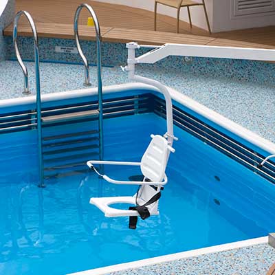 Pool hoist installed on a cruise ship deck to assist passengers entering the pool.