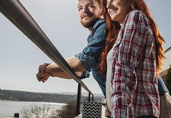 Couple on their balcony enjoying the view.